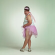 © Yuri Arcurs/peopleimages.com - Sexy legs. An overweight man comically dressed-up in a pink fairy costume showing his leg off.