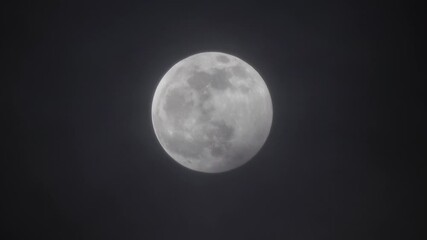 Wall Mural - full moon moving between clouds