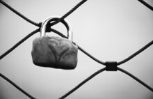 Love Lock With Heart Attached To Bridge In Paris, France. Valentine's Day Background. Lost Love. Black White Historic Photo