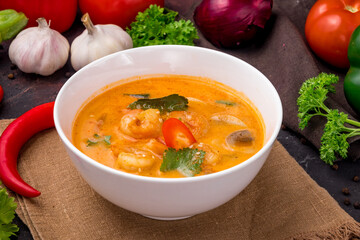 Wall Mural - Tom Yam soup with shrimps on white bowl on dark table