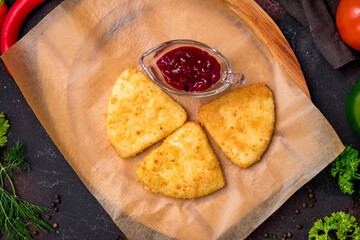 Wall Mural - triangle fried Cheese sticks with berry sauce on the board top view