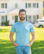 © Olena - smiling mature man realtor standing outdoor at house, new home