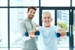 © Camerene P/peopleimages.com - You're stronger than you think. Shot of a friendly physiotherapist helping his senior patient work out with weights.