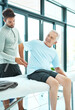 © Camerene P/peopleimages.com - This is where I feel discomfort. Shot of a senior man consulting with his physiotherapist.