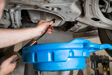 change of old oil in a car engine.