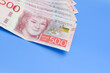 Swedish krona on a blue background with a large denomination