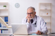 © Elnur - Old male doctor working at the hospital