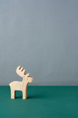 Poster - wood reindeer toy on green table