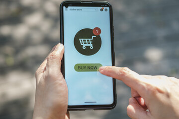 Poster - woman shopping online with credit card at coffee shop in outdoor.close up hand holding smartphone