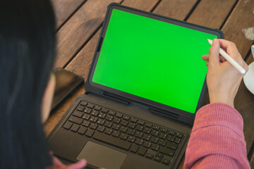 Poster - asian woman working with tablet green screen online at coffee shop