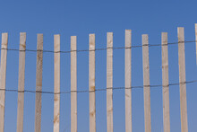 View Of Snow Fence Slats Against Blue Sky