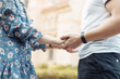 Close-up of a young loving couple holding hands. Romantic concept
