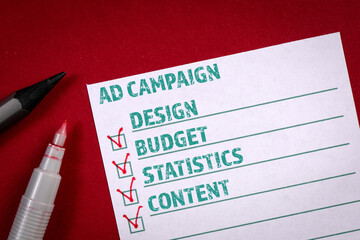 Canvas Print - Ad Campaign checklist. Stationery and a sheet of paper on a red background