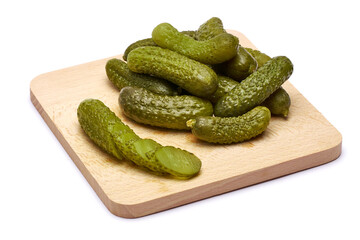 Wall Mural - Tasty Whole green cornichons on wooden serving board isolated on a white background