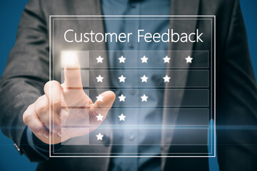Poster - Close up of business man hand pointing at customer feedback hologram on blue background. Rating and ranking concept.