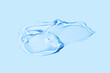 © svetolk - Liquid gel smear isolated on blue background. Beauty cosmetic smudge such as pure transparent aloe lotion, facial jelly serum, cleanser, shower gel or shampoo top view