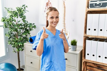 Sticker - Young caucasian woman working at pain recovery clinic pointing fingers to camera with happy and funny face. good energy and vibes.