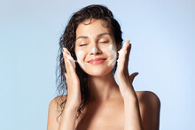 Smiling Young Woman Washing Foam Face By Natural Foamy Gel. Satisfied Girl With Bare Shoulders Applying Cleansing Beauty Product On Cheeks Closed Eyes. Personal Hygiene, Skincare Daily Routine.