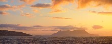 Rocky Shores (cliffs, Mountains) Of The Rock Of Gibraltar At Sunrise, A View From The Sailing Boat. British Overseas Territory. Epic Cloudscape. Travel Destinations, National Landmark, Sightseeing