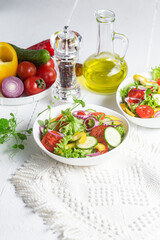 Wall Mural - Vegetable salad with cucumber, tomato, sweet pepper in a white plate