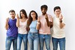 © Krakenimages.com - Group of young people standing together over isolated background doing italian gesture with hand and fingers confident expression