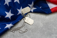 Authentic Military Dog Tag On An American Flag