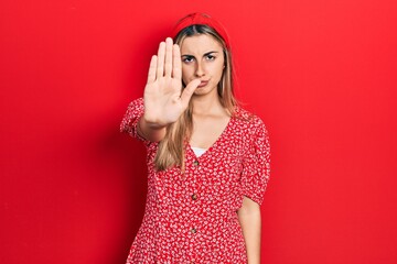 Sticker - Beautiful hispanic woman wearing summer dress doing stop sing with palm of the hand. warning expression with negative and serious gesture on the face.