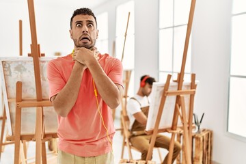 Canvas Print - Young hispanic man at art studio shouting and suffocate because painful strangle. health problem. asphyxiate and suicide concept.