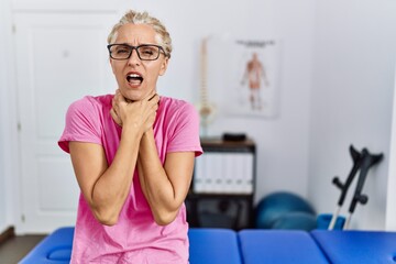 Poster - Middle age blonde woman at pain recovery clinic shouting and suffocate because painful strangle. health problem. asphyxiate and suicide concept.