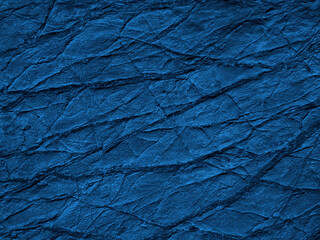 Wall Mural - navy blue abstract background. toned rock surface texture with cracks and veins. close-up. it looks 
