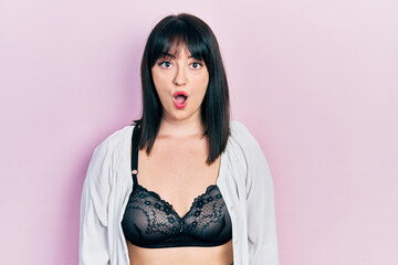 Canvas Print - Young hispanic woman wearing lingerie afraid and shocked with surprise expression, fear and excited face.