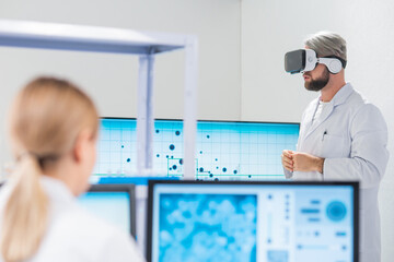 Wall Mural - genetic engineers are using virtual reality technology. professional team of scientists is working o