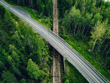 Aerial View Of Country Road Above The Railway In A Green Summer Forest