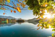 The Famous Alpine Lake Bled, Blejsko Jezero, In Slovenia, Autumn Landscape. Fabulous View Of The Lake, Island With Church, Bled Castle, Mountains And Blue Sky With Clouds, Backdrop In The Fresh Air.