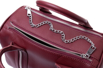 Burgundy leather bag closes with a zipper, decorated with a silver metal chain