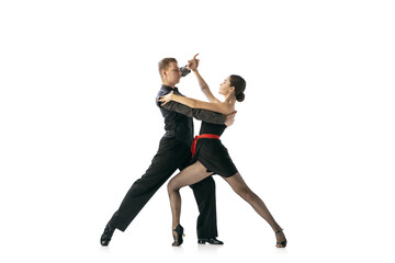 Flexible young couple dancing Argentine tango isolated on white studio background. Artists in black stage costumes