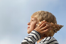 Child Listen To Seashell