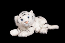 A White Tiger Isolated On A Black Background. Soft Toy