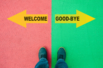 Wall Mural - Welcome or Good-Bye choice, text on asphalt ground, feet and shoes on floor