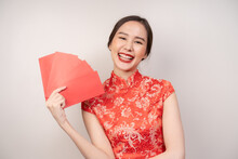 Chinese New Year Festival Celebrate Culture Of China People, Cheerful Asian Young Woman, Girl Hand Holding Red Envelope, Ang Pao ,wearing Red Cheongsam Dress Traditional. Isolated On White Background.