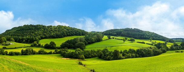 broad panorama of the countryside in north wales with green field in foreground
