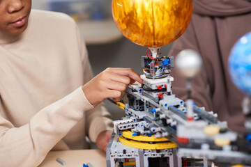 Wall Mural - Close-up of student projecting robot from constructor details for science project