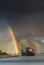 Old Abandoned Boat Near Fort William In The Scottish Highlands With A Double Rainbow Against Ben Nevis On A Stormy Day. Scotland Landscape Photography