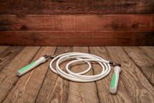 Heavy Fitness Jump Rope On Rustic, Weathered Wood Background