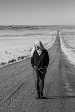USA, Nevada, Winnemucca, Senior Woman Walking Down Desert Road