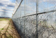 © Tetra Images - USA, Virginia, Security fence in prison