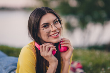 Sticker - Portrait of gorgeous peaceful person arms touch earphones toothy smile look camera spend free time outside