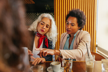 Wall Mural - Lifelong diverse friends catching up over coffee