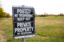No Trespassing Keep Out Sign Near A Large Field