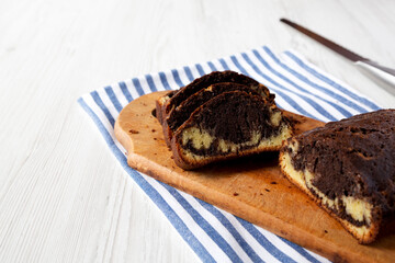 Wall Mural - Homemade Chocolate and Vanilla Marble Cake on a rustic wooden board, side view. Copy space.